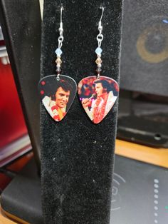 Elvis Presley Guitar Pick Earrings Sterling silver ear wires Austrian  crystals smoked topaz, white and peach. Sterling silver spacers, eye pins and closed jump rings. Approx. 1 1/2 inches. Elvis Presley Guitar, Repurposed Guitar, Elvis Guitar, Guitar Pick Earrings, Silver Eye, Eye Pins, Guitar Picks, Austrian Crystal, Earrings Sterling Silver