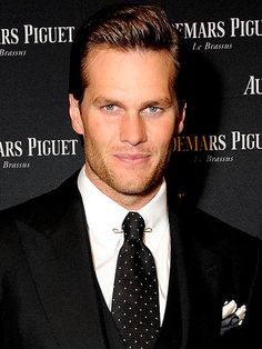 a man in a suit and tie posing for the camera