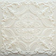 a white pillow with an intricate design on it