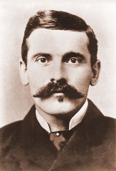 an old black and white photo of a man with a mustache