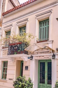 an old building with green doors and windows