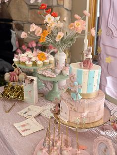 a table topped with lots of cakes and cupcakes