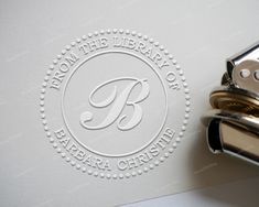 a stamp with the letter b on it and a pair of scissors next to it