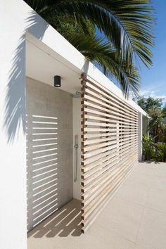 a white wall with wooden slats on it