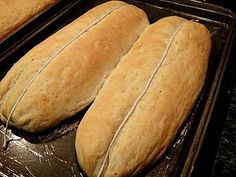 three loaves of bread sitting on top of a pan