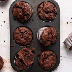 chocolate muffins in a baking pan on a table