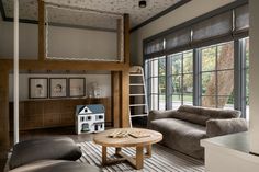 a living room filled with furniture and lots of windows