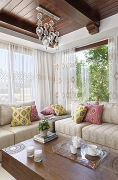 a living room with two couches and a coffee table in front of a window