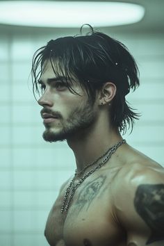 a man with long black hair and piercings on his chest standing in a bathroom