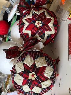 two red and white ornaments sitting on top of a table