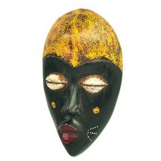 a black mask with yellow spots on it's face and eyes, against a white background