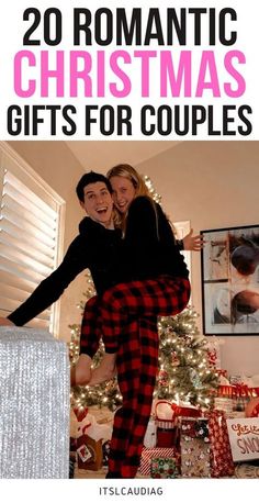 a man and woman are hugging in front of a christmas tree