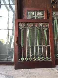 an old wooden door with stained glass panels