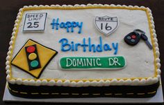 a birthday cake that is decorated with traffic signs and road names on the top layer