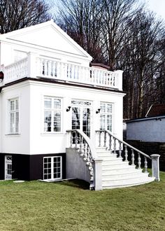 a large white house with black and white trim