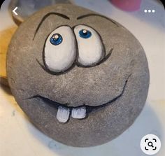 a close up of a rock with a smiley face on it's face and eyes