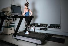 a woman is running on a treadmill