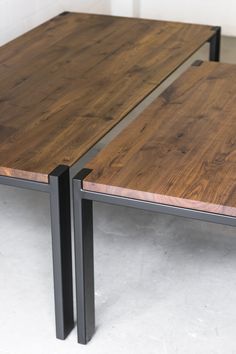 two tables made out of wood and metal are sitting side by side on the floor