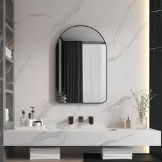 a bathroom with marble walls and flooring, mirrors on the wall above the sink