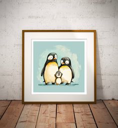 two penguins sitting next to each other in front of a white brick wall and wooden floor