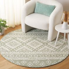 a white chair sitting on top of a wooden floor next to a green and white rug