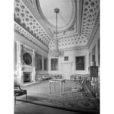 an old black and white photo of a living room with chairs, fireplace and chandelier