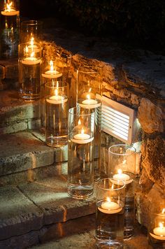 many lit candles are on the steps outside