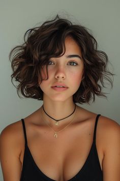 a woman with short hair wearing a black top and choker necklace on her neck