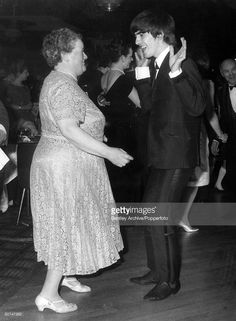 an old photo of two people dancing at a party