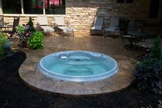 a hot tub sitting in the middle of a patio