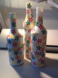 three decorative bottles are sitting on the counter