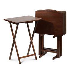 two wooden folding tables with one sitting on the floor and another standing up against it