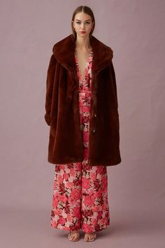 Tortoise shell buttons at front Full lining Heavy weight fluffy coating fabric In seam pockets Relaxed fit Long length fur coat Metal press stud on inside of lapel Overlaps at the front Woven