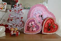 valentine's day decorations are displayed on a shelf