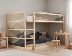 a child's bedroom with two bunk beds and a desk in front of the bed