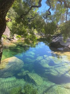 the water is crystal blue and green in this photo, it looks like there are rocks on either side