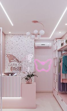 a pink closet with clothes hanging on the walls and lights in the ceiling above it