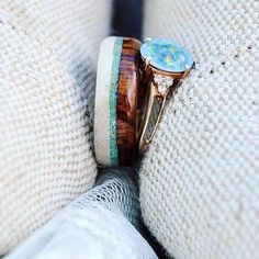 two rings with different designs on them sitting next to each other in front of a white sweater