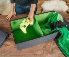 a person holding a video game controller in a box