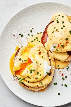 an open face sandwich with eggs and mayonnaise on it sitting on a white plate