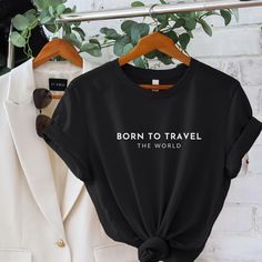 Born To Travel The World Soft Cotton T-shirt. Made With Love & Purpose. This T-shirt is a Love at first sight. There's nothing better than a shirt that makes you feel comfortable and stylish at the same time. Style this modern T-shirt with a skirt, jeans or leggings, add a piece of jewelry, put on your favorite shoes and you're ready to go make memories. This tee makes a perfect gift for all Travel Lovers.  GENERAL INFORMATION - Bella And Canvas Brand Shirts - Unisex Adult Sizing - Rolled Sleeve Capsule Clothing, Clothing Minimalist, Travel Tshirt, Skirt Jeans, Minimalist Shirts, Travel Capsule, Travel Shirt, Capsule Outfits, Brand Shirts