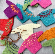 several felt ornaments are laid out on a table