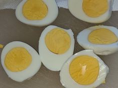 four hard boiled eggs on a baking sheet