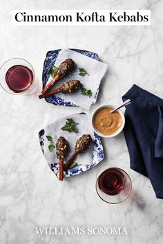 two plates with meatballs and dipping sauces on them next to glasses of wine