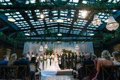 a bride and groom are standing at the alter in front of their wedding ceremony guests