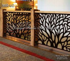 an image of a wooden and metal gate with trees on the front, and two lamps above it