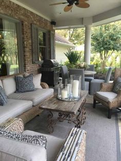 an outdoor living area with couches, tables and chairs