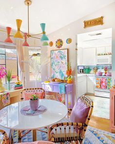 an image of a kitchen with colorful decorations on the walls and furniture in the room