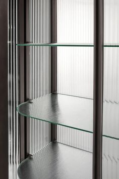 glass shelves in the corner of a room