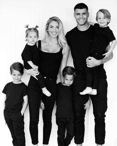 a family poses for a black and white photo